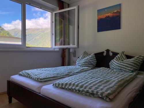 a bedroom with two beds in front of a window at 3-Zimmer Appartement in Zwieselstein (Sölden) in Sölden