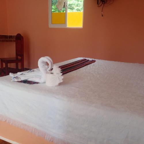 a white bed with a towel on top of it at Motel Champoton sobre carretera frente al mar in Champotón