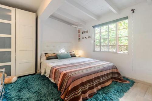 a bedroom with a bed in a room with a window at Villa Can Cozy in Ibiza Town