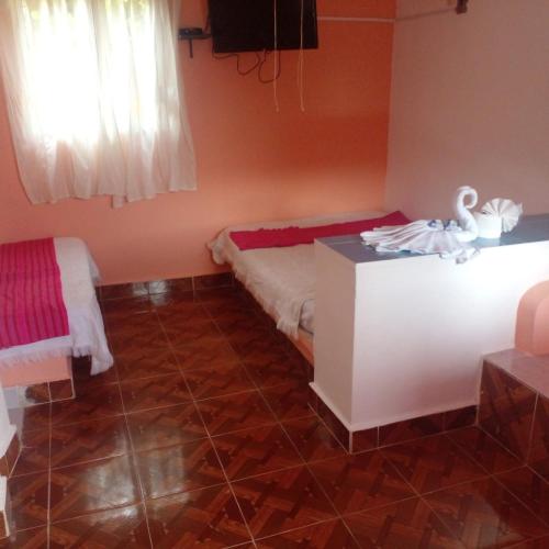 a bedroom with a bed and a table with a swan on it at Motel Champoton sobre carretera frente al mar in Champotón