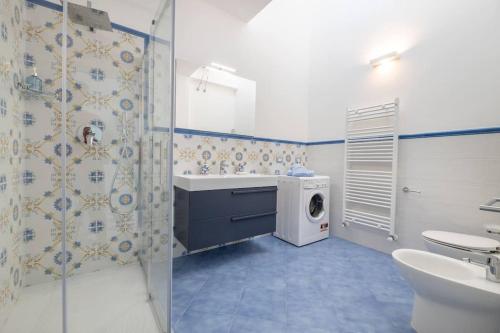 a bathroom with a sink and a washing machine at Belvedere Apartments B in Marina di Mancaversa