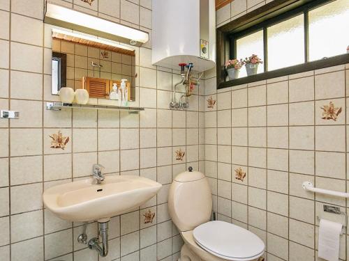 a bathroom with a toilet and a sink at Holiday home Hvide Sande XIX in Hvide Sande