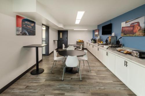 a kitchen with tables and chairs and a counter at Baymont by Wyndham Laredo in Laredo