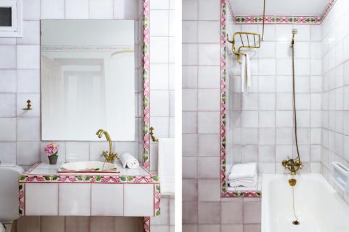 La salle de bains est pourvue d'une baignoire, d'un lavabo et d'un miroir. dans l'établissement La Casa de San Fernando con vistas a los Reales Alcázares, à Séville