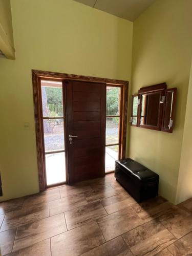 an empty room with a door and a wooden floor at NATURALMENTE in Santa Ana