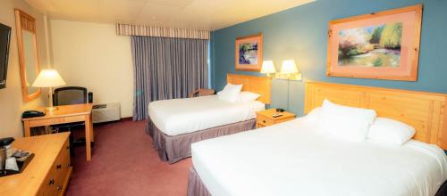 a hotel room with two beds and a television at The Federal Hotel Downtown Carson City, an Ascend Collection Hotel in Carson City