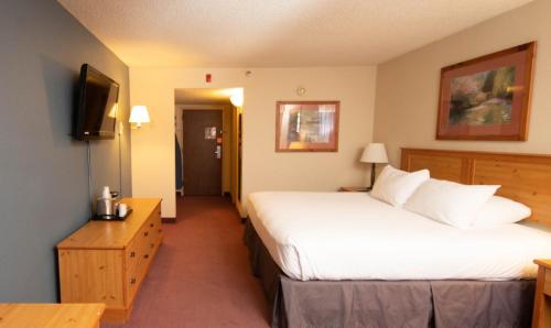 a hotel room with two beds and a television at The Federal Hotel Downtown Carson City, an Ascend Collection Hotel in Carson City