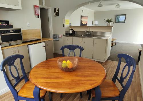 a kitchen with a wooden table with a bowl of fruit on it at Home Away From Home in Richmond