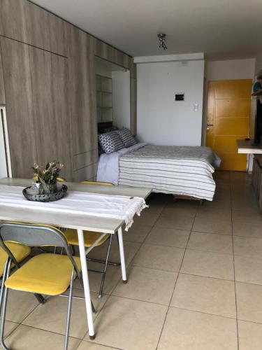 a room with a bed and a table and chairs at 11 De Septiembre 3255 in Mar del Plata