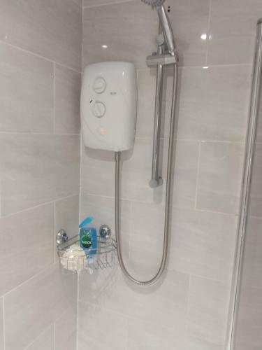 a shower with a shower head in a bathroom at Riverside in Liverpool