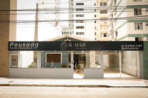 a store front with a black and white sign at Pousada Al Mare in Balneário Camboriú