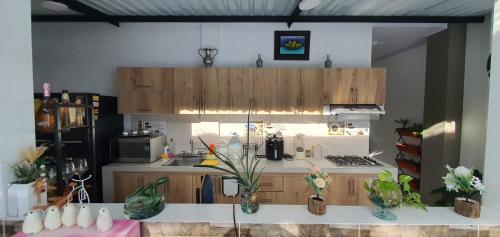 a kitchen with wooden cabinets and a white counter top at Como en casa in La Dorada