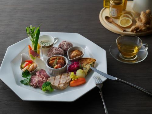 a plate of food with meat and vegetables on a table at Hotel Laforet Nasu in Nasu