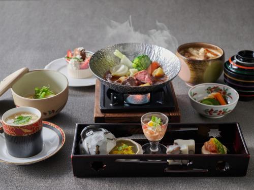 a table with a tray of food and bowls of food at Hotel Laforet Nasu in Nasu