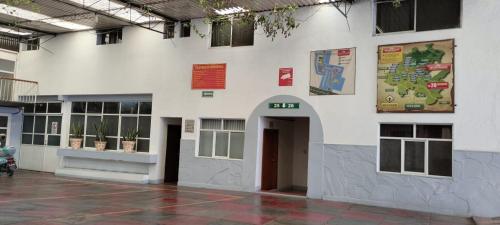 a large white building with a door in it at Hotel Avenida Ixmiquilpan in Ixmiquilpan