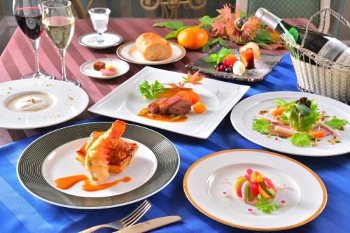 a table with plates of food on top of it at Hotel Listel Inawashiro Wing Tower in Inawashiro