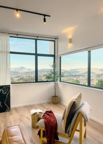 a living room with a large window overlooking the city at Amazing view Architech Home 8Minutes to Hobart CBD in Hobart