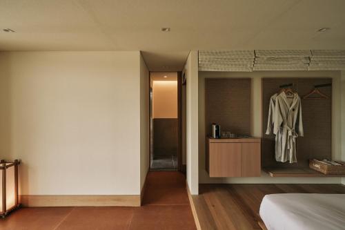 a bedroom with a dresser and a mannequin in a room at IJE Gyeongju in Gyeongju