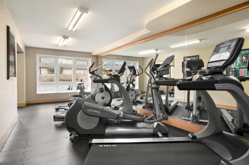 a gym with treadmills and elliptical machines at Canmore Inn & Suites in Canmore