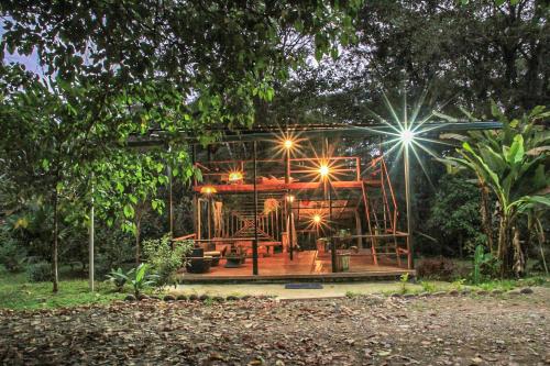 a building with lights in the middle of a forest at Kuyana Amazon Lodge in Archidona