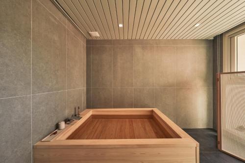 a bathroom with a wooden tub in a room at IJE Gyeongju in Gyeongju