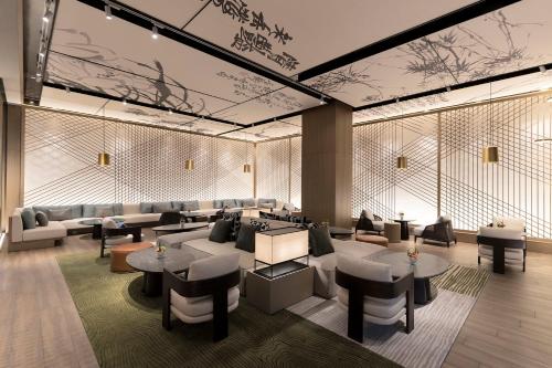 a lobby with couches and tables and chairs at Hotel Indigo Anji in Anji