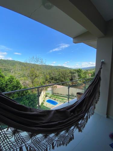 a hammock on the balcony of a house at Estadia Fox in Lençóis