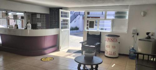 a kitchen with a bar and a table in a room at Hotel Avenida Ixmiquilpan in Ixmiquilpan