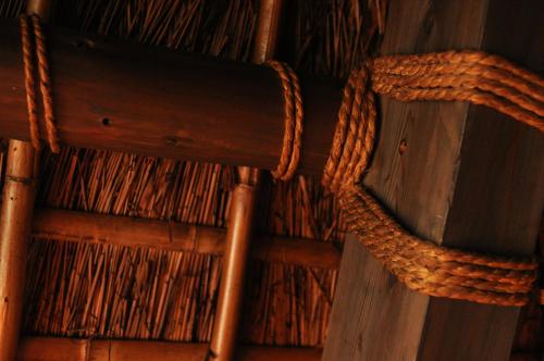 a wooden wall with a rope on it at Hokyuann - 邦久庵 in Motogoe