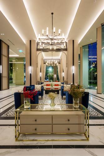 a living room with a lobby with a table and chairs at Somerset Pattaya in Pattaya Central