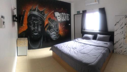 a bedroom with a large poster of a bust of a man at Bonkers Guesthouse in Pattaya Central