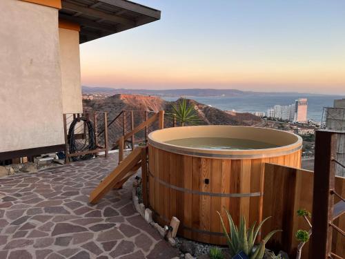 a hot tub on a patio with a view of the ocean at Native Residence in Rosarito