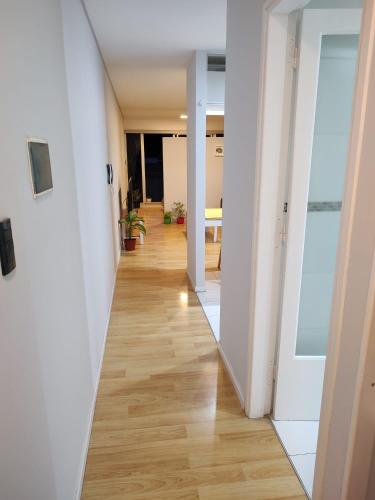 a hallway of an office building with a mirror at El Racimo in Ciudad Lujan de Cuyo