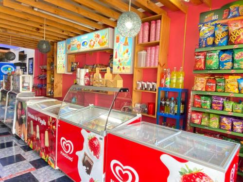 a store with a strawberry counter in a store at Hostal y Complejo Recreacional La Playita de Monse in Otavalo