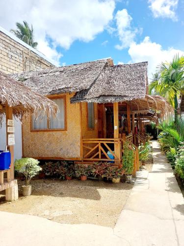 a small house with a straw roof at Jake and Zyra Place in San Vicente