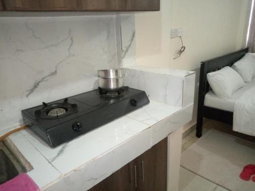 a kitchen with a stove on a counter in a room at The pinnacle in Kikuyu