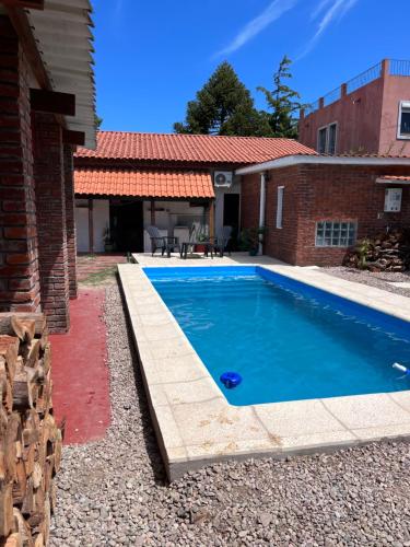 a swimming pool in the backyard of a house at Camunda in Punta del Este