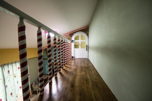 a hallway with a white door and a wooden floor at Hi Kids B&B in Zhixue