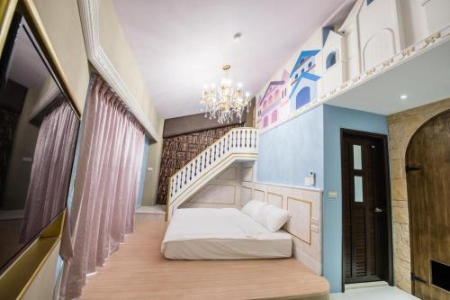 a bedroom with a bed and a stair case at Hi Kids B&B in Zhixue