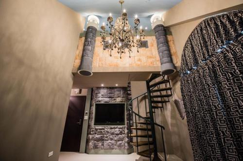 a hallway with a chandelier and a staircase in a house at Hi Kids B&B in Zhixue
