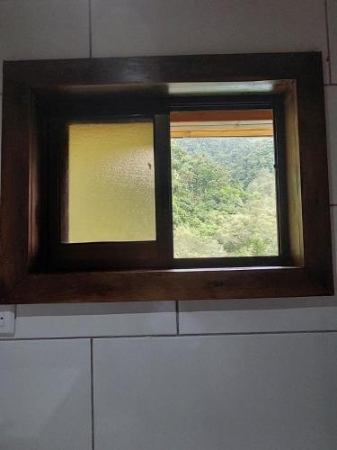 a window in a kitchen with a view at Tail's room in San Gerardo de Dota