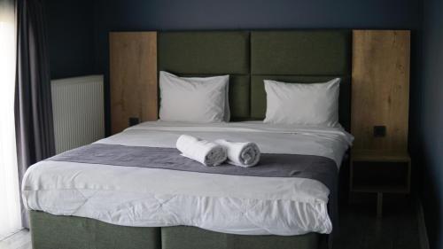 a bedroom with a bed with two towels on it at Centrum Residence in Ankara