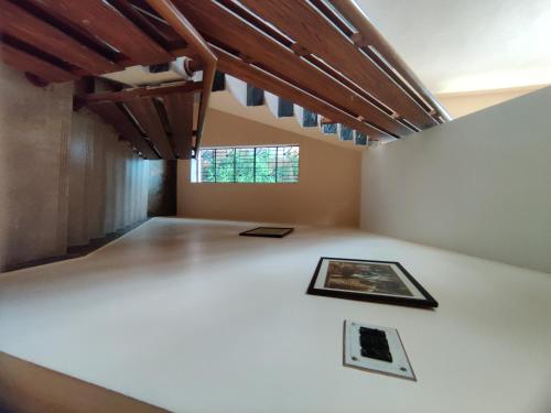 a room with a white floor and a window at Abode of Peace in Bolpur