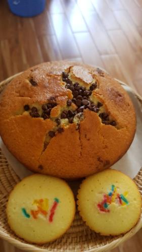 a bundt cake with sprinkles on it with two cookies at Bloom Garden Bed & Breakfast in Siem Reap