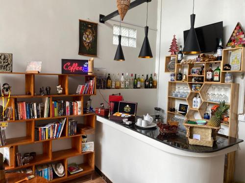 a bar in a room with books at Bloom Garden Bed & Breakfast in Siem Reap