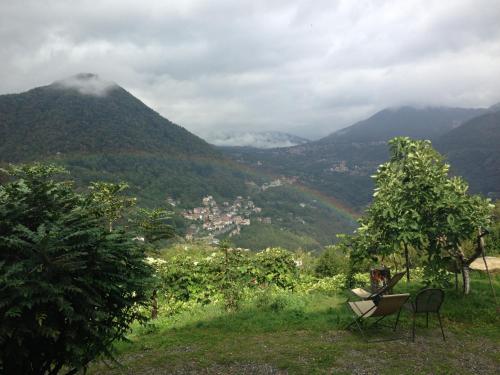 a woman sitting in a chair looking at a mountain at Agriturismo Al Marnich in Schignano