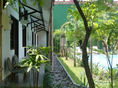a house with a garden and a swimming pool at Pondok IJo Villa in Timuran