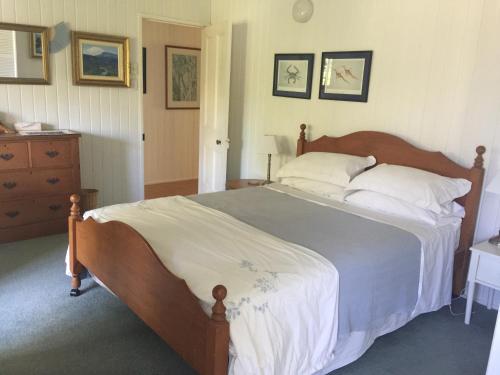 a bedroom with a large bed and a dresser at Pottsville Beach House in Pottsville