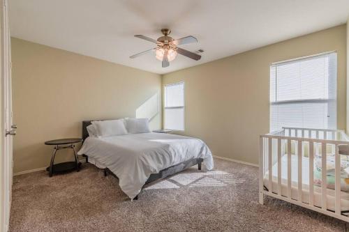 a bedroom with a bed and a ceiling fan at Cozy 2BD/3BA with Balcony/Patio/Free Parking/Fast Wifi! 5min to Downtown Plano! in Plano