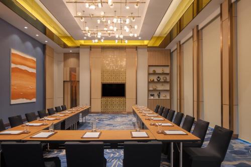 a large conference room with long tables and chairs at Hyatt Regency Trivandrum in Trivandrum